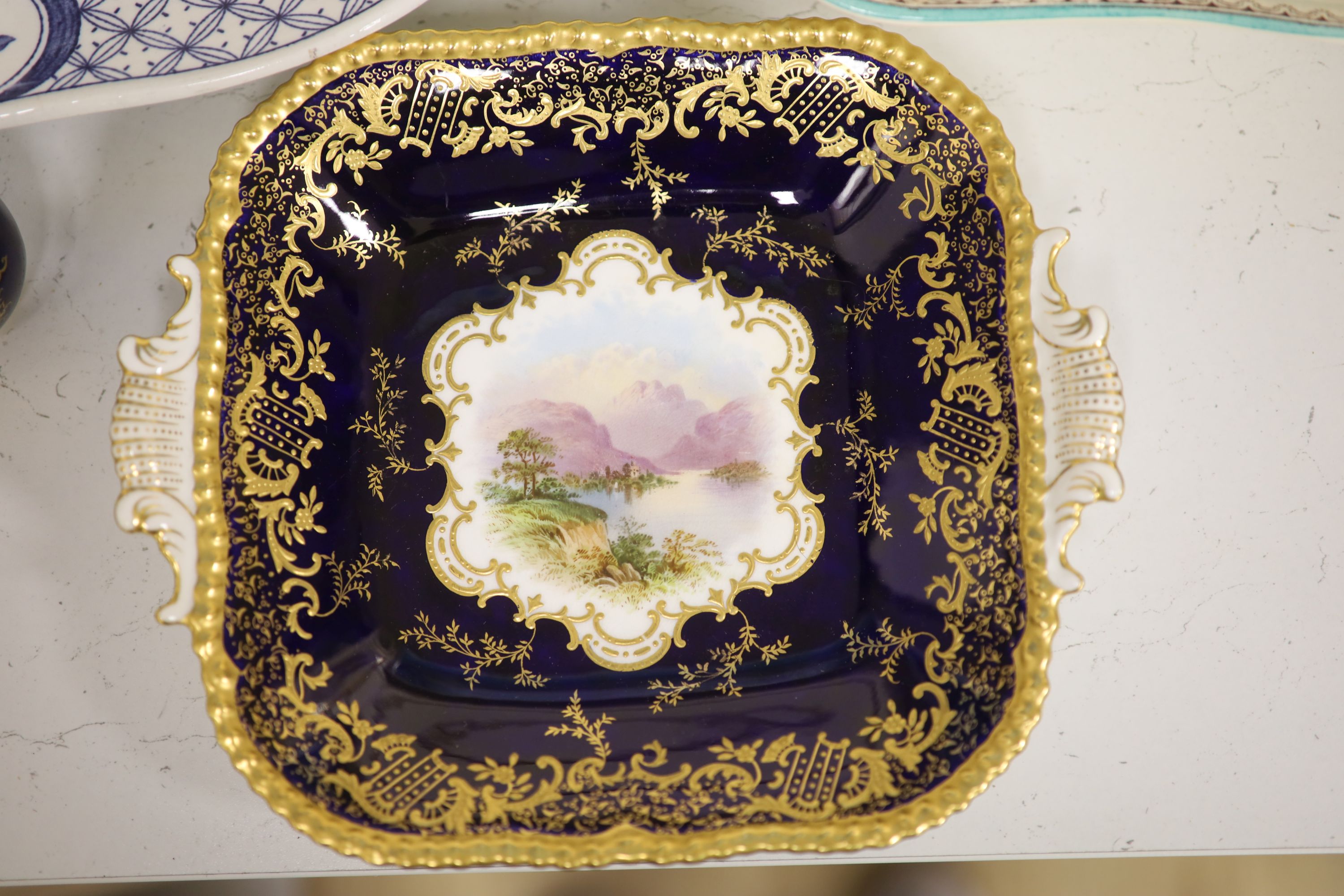 A Coalport cobalt blue dish with painted reserve of Kilchurn, heightened in gilt and sundry ceramics,